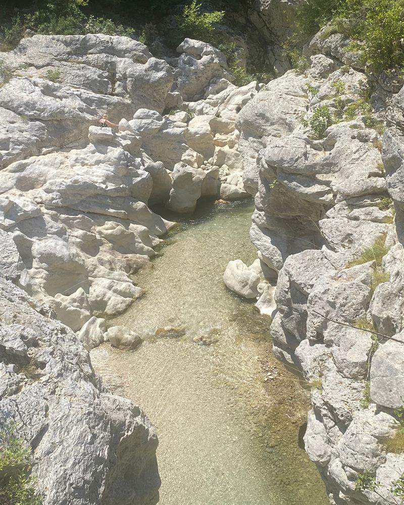 The clear waters of the Acheron carving through white sculpted rock at Glyki